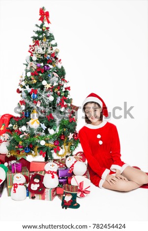 Pretty girl sitting by christmas tree on white background,studio shot.There has blank space for text.