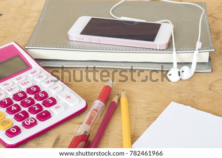 notebook monthly planner record with mobile phone and calculator for financial on office desk