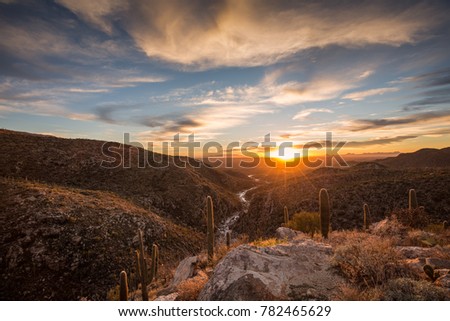 The summer sun is setting over Tucson, Arizona and reflecting off a stream in Tanque Verde  Canyon.