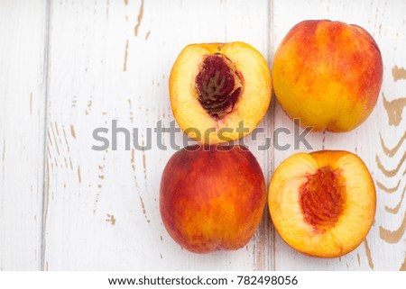 a lot of fresh peaches on a white table. Top view