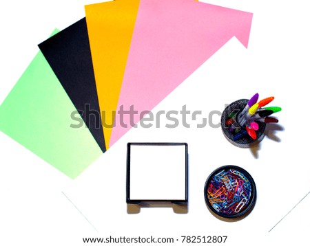 Colored paper on a white background and office chancery.