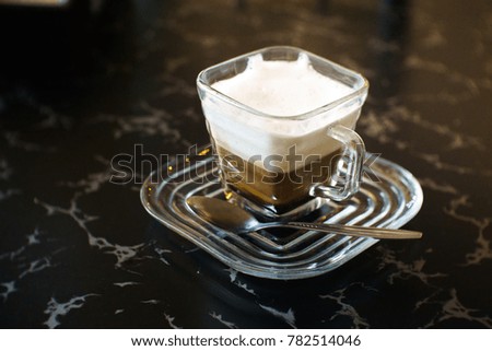 Coffee cappuccino on the table with blur background