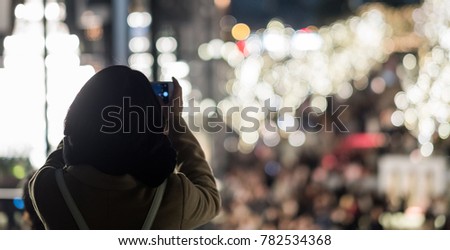 Woman taking picture with smartphone. Selective focus
