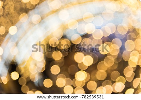 glittering stars on bokeh. orange and yellow tone of christmas or celebration light with blurry focus. Abstract background with bokeh effect.