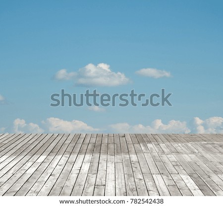 wooden floor against the sky with clouds