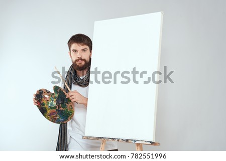  painter with a palette and brush on a light background                              