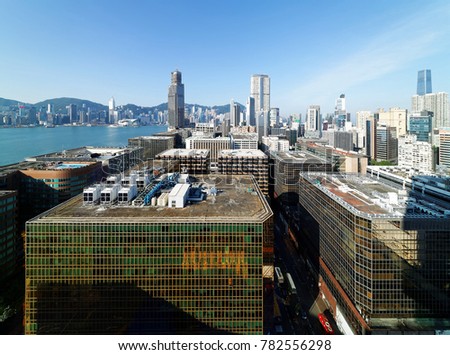 Aerial scenery of Hong Kong, viewed from Tsim Sha Tsui in Kowloon, with a city skyline of crowded skyscrapers by Victoria Harbour under blue clear sky ~ Beautiful cityscape of Hongkong on a sunny day