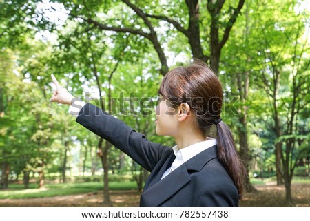 Job-seeking student pointing to sky