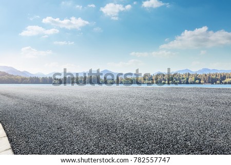 asphalt road and lake with mountain nature landscape