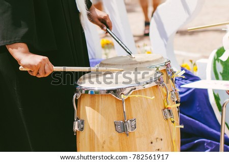 Hand of woman playing drum,People hands playing outdoor drums, thailand