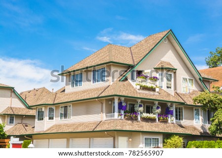 Top of big luxury residential house on blue sky background