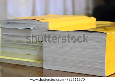 selective focus books stack on wooden desk in office or public library room or book store,abstract blur background and space for text.concept for education,background.