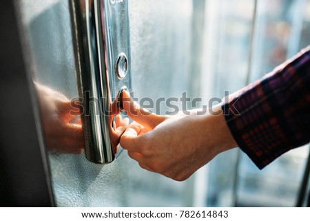 The thumb presses the Elevator button, a hand reaching for the button, the girl waiting for Elevator, push button start, isolated