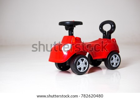small size Toddler Red Car on isolated gray background "This photo may contain blur image and grain due to low light and soft focus shot"