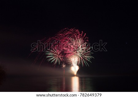 New Year's Eve Fireworks launched from the water with reflections