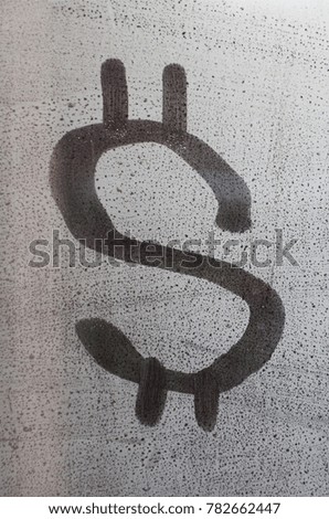 The dollar symbol on the misted sweaty glass. Abstract background image. US money concept