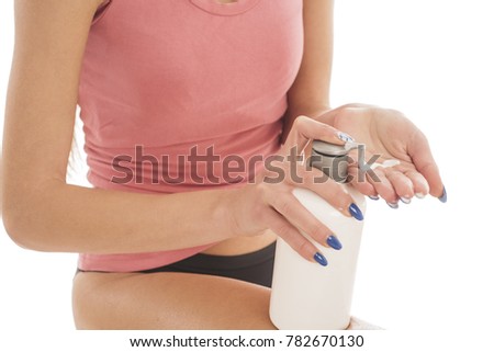 girl squeeze a bottle of body lotion. isolated