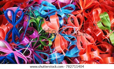 Closeup Texture of Multicolor Plastic Ribbon Bows for Gift / Present Decoration, Celebration, Party, Background, Backdrop, or Wallpaper.