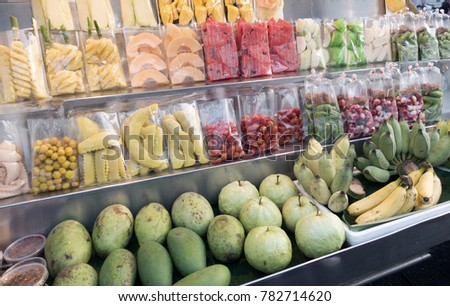 Different kind of tropical fruits. Cutting Fruits. Royalty-Free Stock Photo #782714620