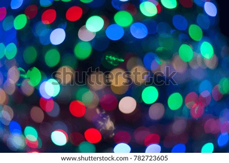 Blurred of colorful bokeh abstract on unfocused background with metal net foreground, blurred bokeh for wallpaper, Christmas and new year festival, red, green blue, orange bokeh