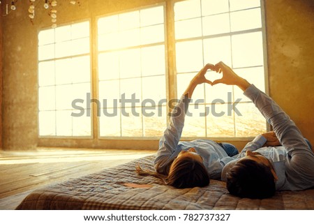 Couple makes a gesture with a hand symbol of the heart. 
