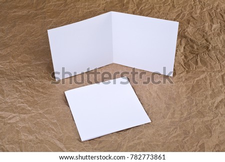 Identity design, corporate templates, company style, blank white greeting card at a wrinkled paper background