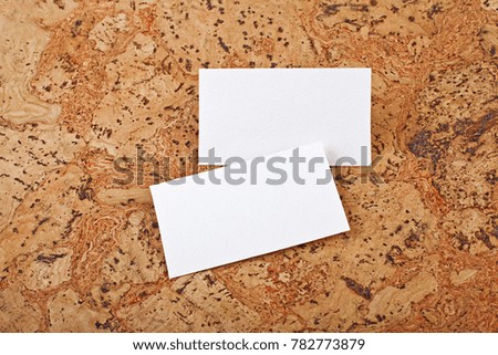 Mockup of white business cards at a cork background. Template for branding identity