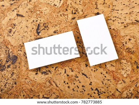 Mockup of white business cards at a cork background. Template for branding identity