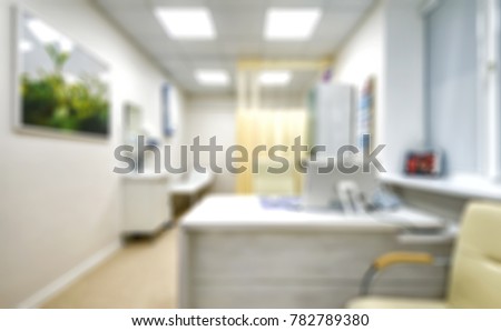 Doctor's office as creative abstract blur background. Light interior of doctor's office in modern clinic. Blurred image of cabinet or consulting room for medical concept.