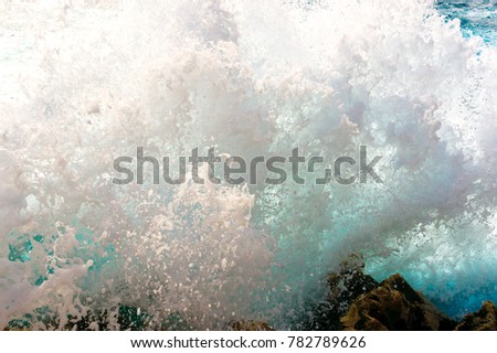 Big crashing wave against a rocky beach