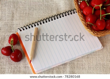 Juicy cherries  and notebook with space for text
