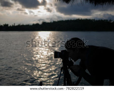 a man taking photo in a middle of the sea