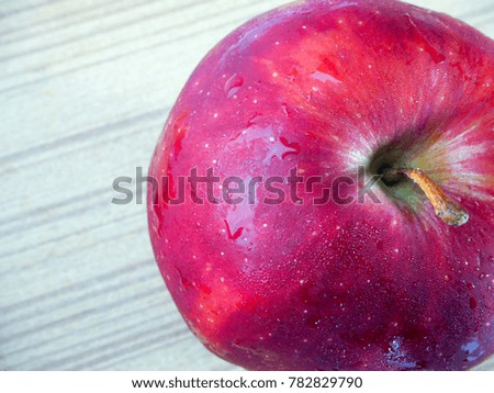 Ripe red apple on wooden background