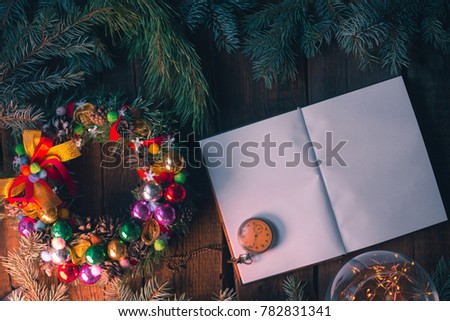 New Year's background. Notepad on wooden boards with decorations.