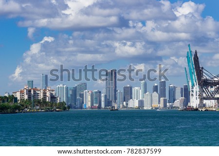 USA, Florida, Miami City Skyline with harbour cranes from sout pointe pier park