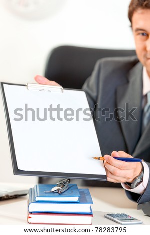 Businessman giving document and pen for signing. Closeup