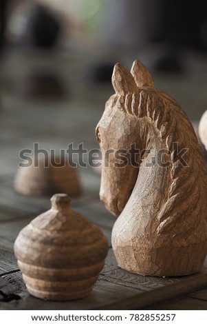 Ancient Thai wooden chess on the board ready to play, selective focus