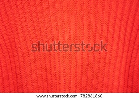 Close up beautiful red craft sweater texture.