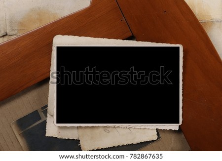 old wooden frame and blank photo on vintage paper background