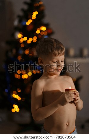 Small cute boy with candle