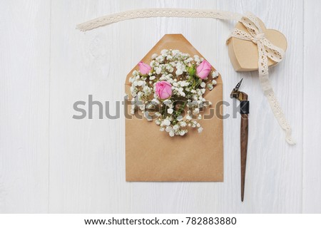 mockup Letter with flowers and calligraphic pen greeting card for St. Valentine's Day in rustic style with place for your text, Flat lay, top view photo mock up