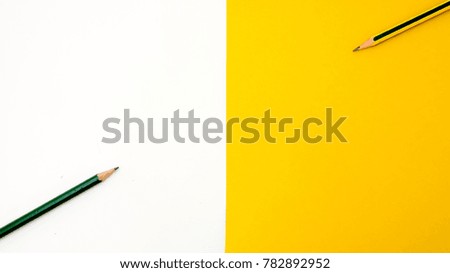 pencil  on the book white and yellow background