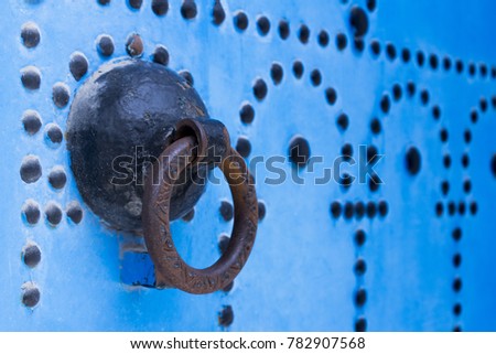 This picture represents detailed door knocker in tunisian arabic style located in beautiful place Sidi Bou Said, Tunisia