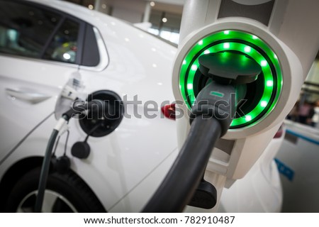 Close up image of the power socket of an electric car, charging. Royalty-Free Stock Photo #782910487