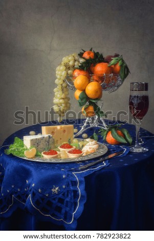 Still life with deliciacies and fruits
