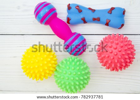 Pet care, veterinary, grooming concept. Pets having fun. Colorful rubber squeaky toys- balls and bones. Space for your text or product display. Royalty-Free Stock Photo #782937781