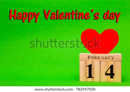 Happy Valentines Day card with red paper heart and wooden calendar on green background