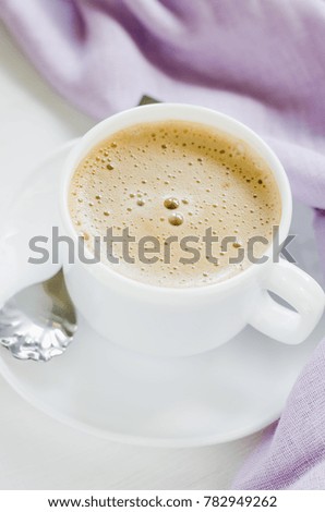 White cup of morning coffee or cappuccino. Cozy breakfast.