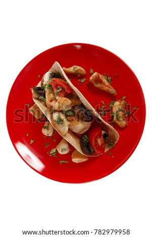 big mexican taco with tomatoes and mushroom on red plate isolated over white background