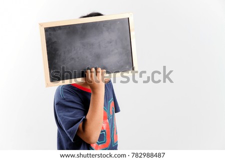 Kid holding an empty blackboard and cover his face